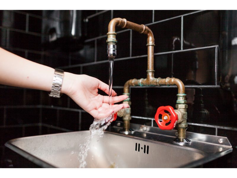 Woman washing hands in sink